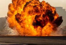 Israeli Strikes Kill Child During Ceasefire Fireball explosion with thick smoke on an open ground