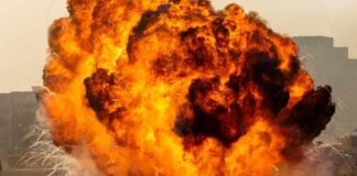 Fireball explosion with thick smoke on an open ground