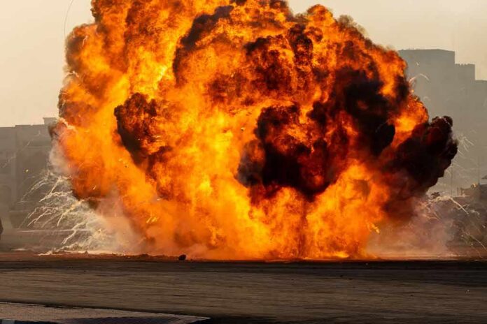 Fireball explosion with thick smoke on an open ground