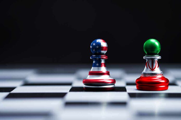 Two chess pawns with U.S. and Iran flag designs on a board