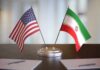 United States and Iran desk flags on a stand