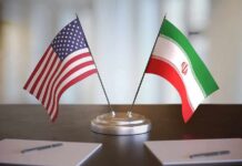 United States and Iran desk flags on a stand