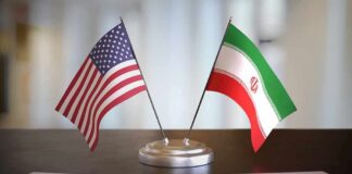United States and Iran desk flags on a stand