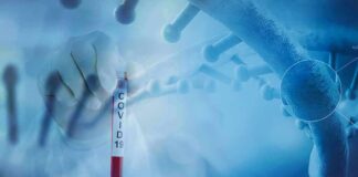 Gloved hand holding a COVID-19 test tube beside a stylized DNA helix