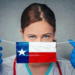 Healthcare worker holds a face mask with Texas flag design