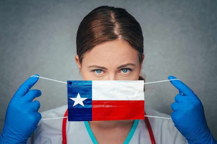 Healthcare worker holds a face mask with Texas flag design