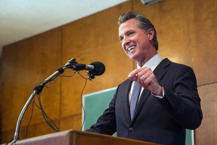 shutterstock_2042504627 Speaker in a suit addressing an audience at a podium