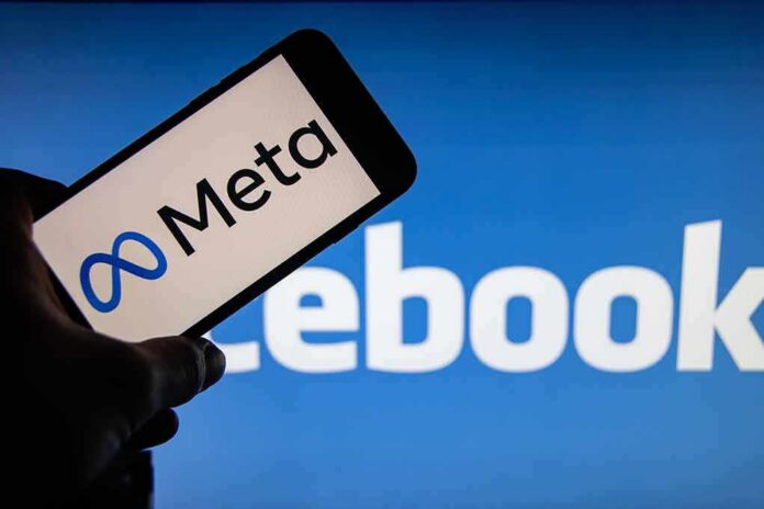Smartphone showing Meta logo against blurred Facebook background