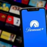Smartphone showing Paramount+ app on blue screen