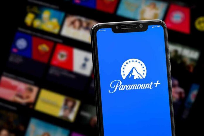 shutterstock_2167805593 Smartphone showing Paramount+ app on blue screen