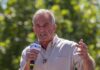 Man speaking into a microphone outdoors