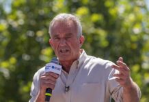 Man speaking into a microphone outdoors