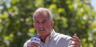 Man speaking into a microphone outdoors