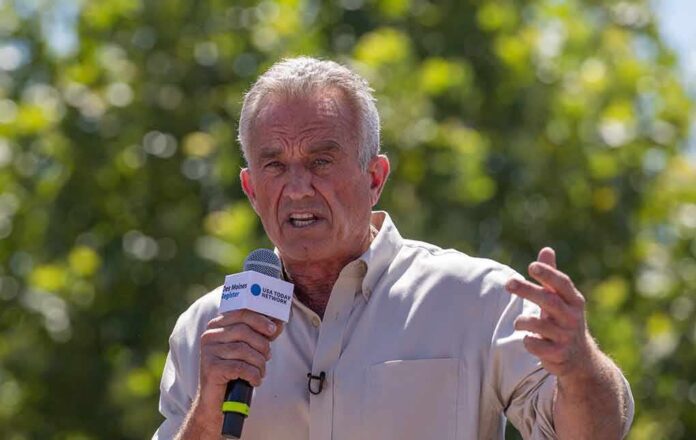 shutterstock_2346739557 Man speaking into a microphone outdoors