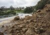 Rockslide blocking a curved mountain road