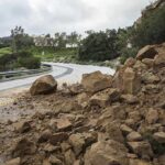Rockslide blocking a curved mountain road