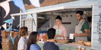 food truck staff serve drinks to customers at window