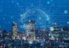 City skyline at night with digital network overlay