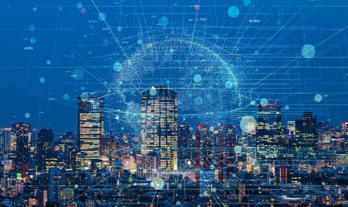 shutterstock_1025003299 City skyline at night with digital network overlay