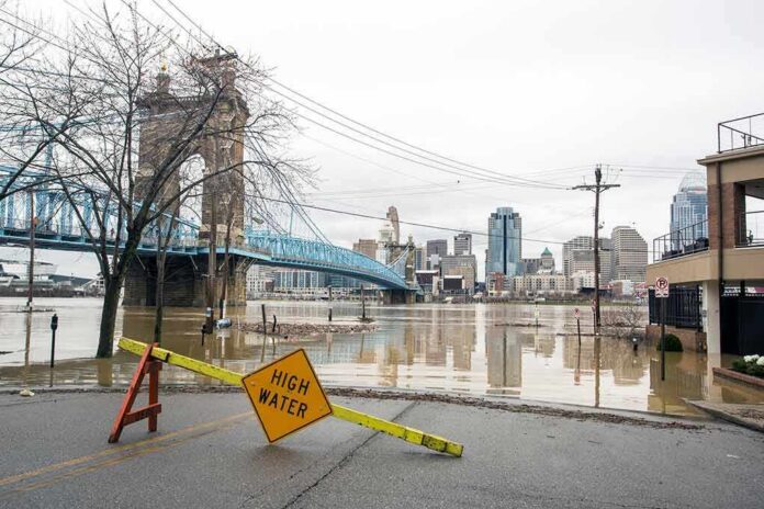 Flooded riverfront with bridge and city skyline