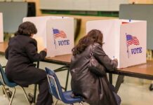 Voters filling out ballots at polling booths