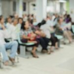 Crowd of people waiting in a hospital waiting area