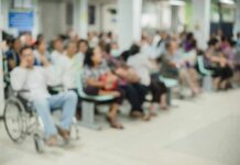 Crowd of people waiting in a hospital waiting area