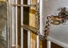 Prison cell door with key and chain in lock