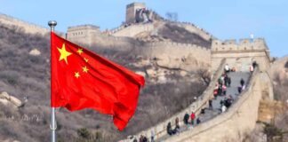 Chinese flag waving with the Great Wall in the background