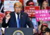 politician speaking at rally podium