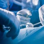 Surgeons' gloved hands performing an operation