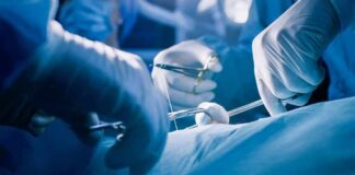 Surgeons' gloved hands performing an operation