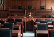 Empty courtroom with wooden benches and judge's bench