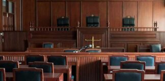 Empty courtroom with wooden benches and judge's bench