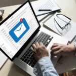 New California Law Puts Speech At Risk Hands typing on laptop with new email notification icon on screen
