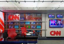 CNN Panic After Paramount Breakthrough CNN newsroom set with red chairs and multiple TVs