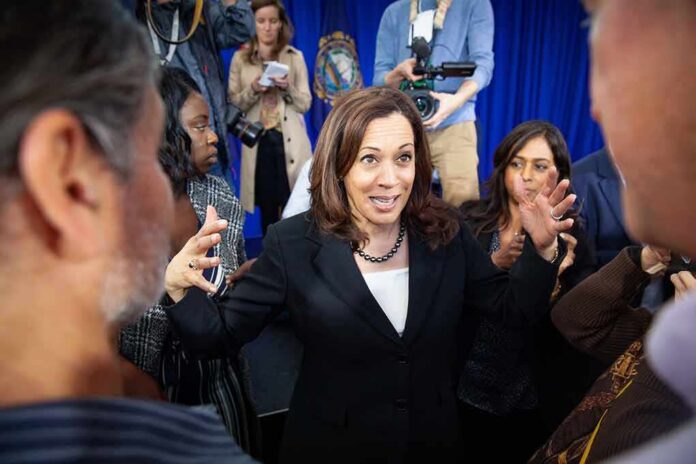 shutterstock_1380838391 Kamala Harris speaks to a crowd as Maya Harris stands nearby