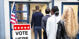 Voters standing in line at a polling place entrance