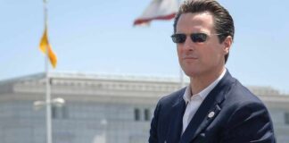man in suit wearing sunglasses outdoors