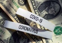 U.S. dollar bills with labels reading COVID-19 and coronavirus