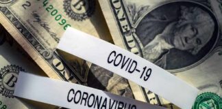 U.S. dollar bills with labels reading COVID-19 and coronavirus