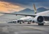 Commercial airliners lined up on an airport taxiway at dusk