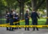 Shots Ring Out Steps From Stadium crime scene tape with police officers in a park