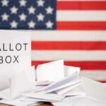 Historic GOP Runoff Produces Clear Winner Ballot box with papers in front of an American flag
