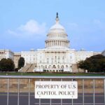 Canada Faces Trump’s New Trade Push View of the U.S. Capitol building with a security barrier in front