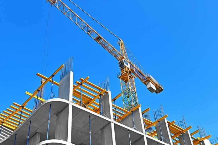 shutterstock_1920687122 Tower crane over concrete building under construction