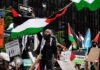 Protesters wave Palestinian flags at a city street demonstration