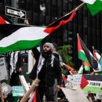 Protesters wave Palestinian flags at a city street demonstration