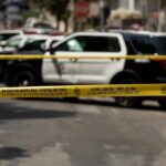 Los Angeles Airspace Roulette Exposed Police tape cordoning off street with patrol SUVs behind