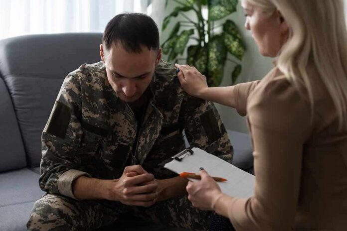 Soldier in camouflage receives support from a counselor